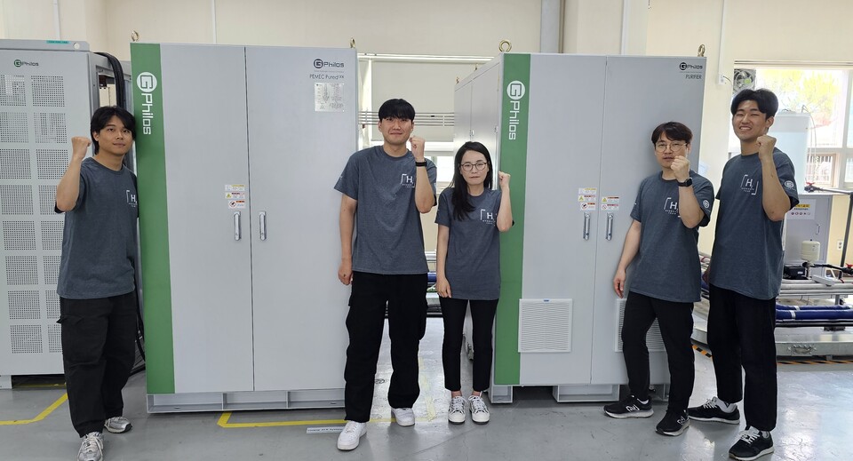 KGS 수소용품 인증을 받은 지필로스 직원들이 100kW 수전해시스템 앞에서 기념촬영을 하고 있다.(사진=지필로스)