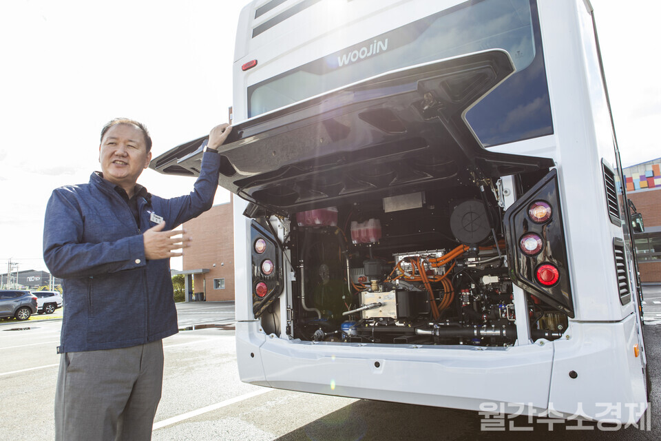 김광석 부사장이 새롭게 개발 중인 120kW급 수소버스 차량의 엔진룸을 열어 보이고 있다.(사진=성재경)